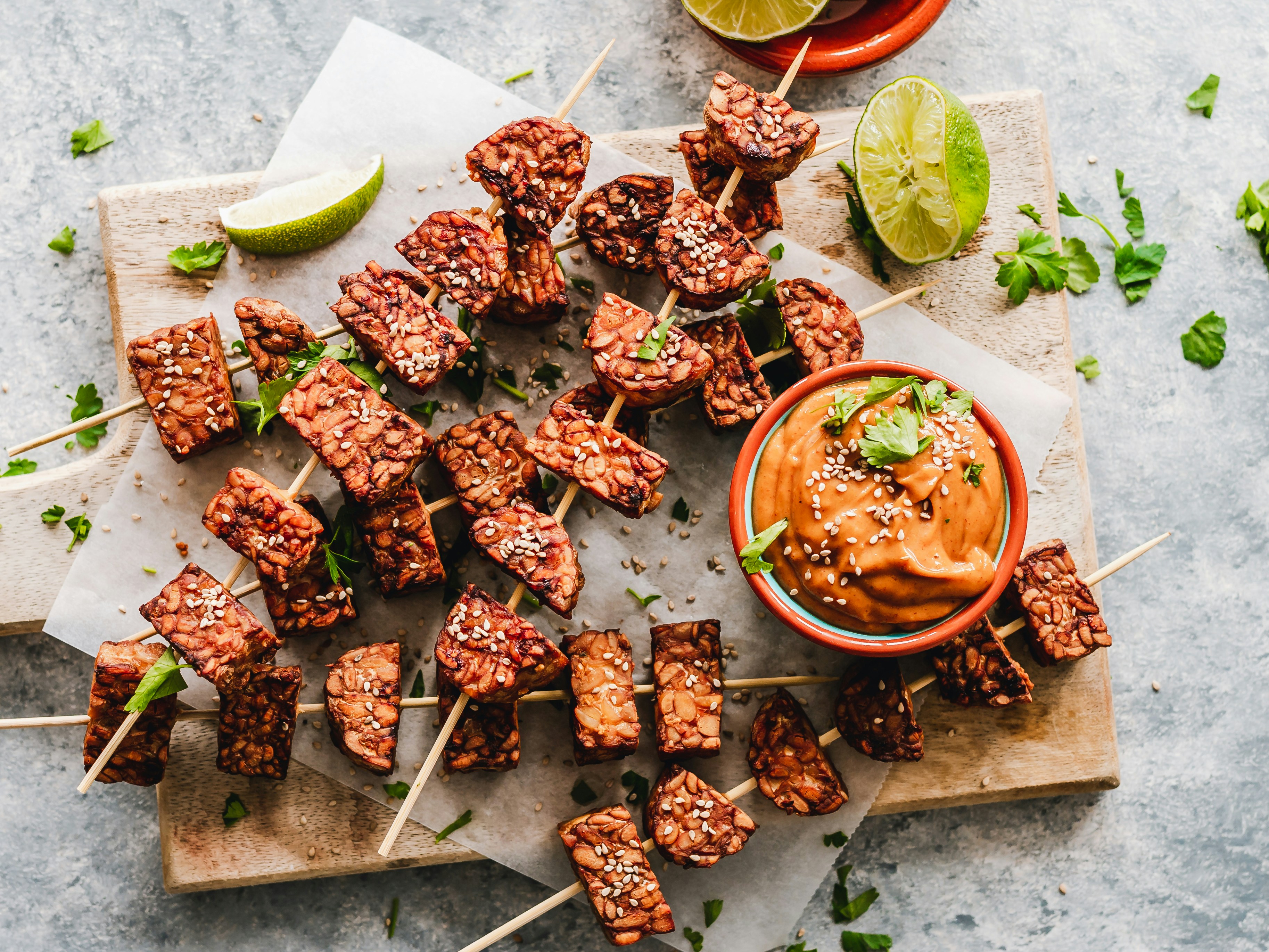 Sesame tempeh skewers with spicy peanut sauce